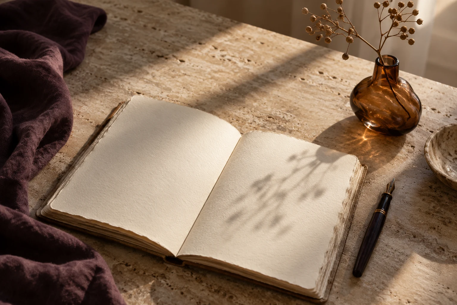 A blank journal and fountain pen in warm afternoon light